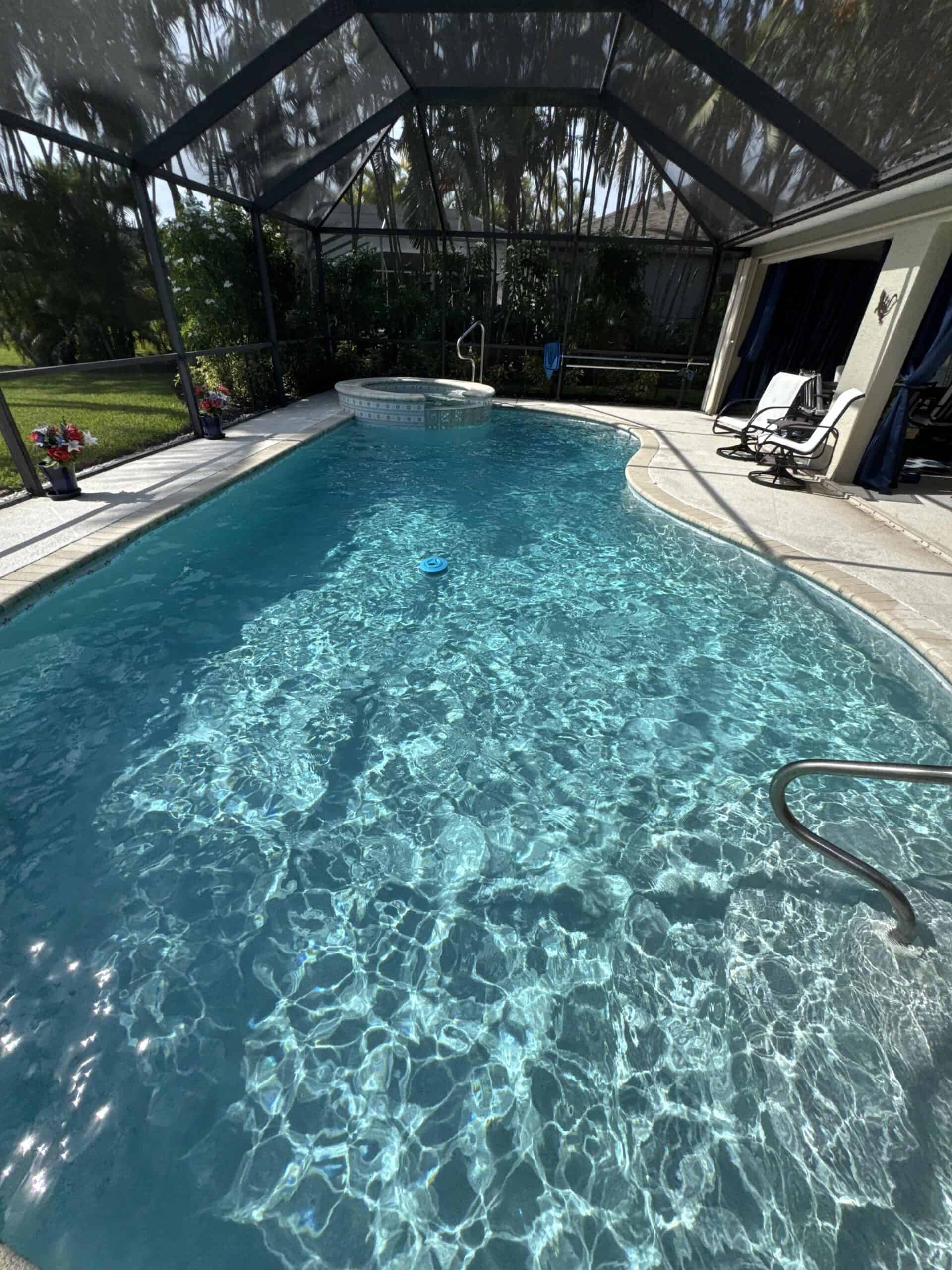 Clear blue pool maintained through recurring professional pool service