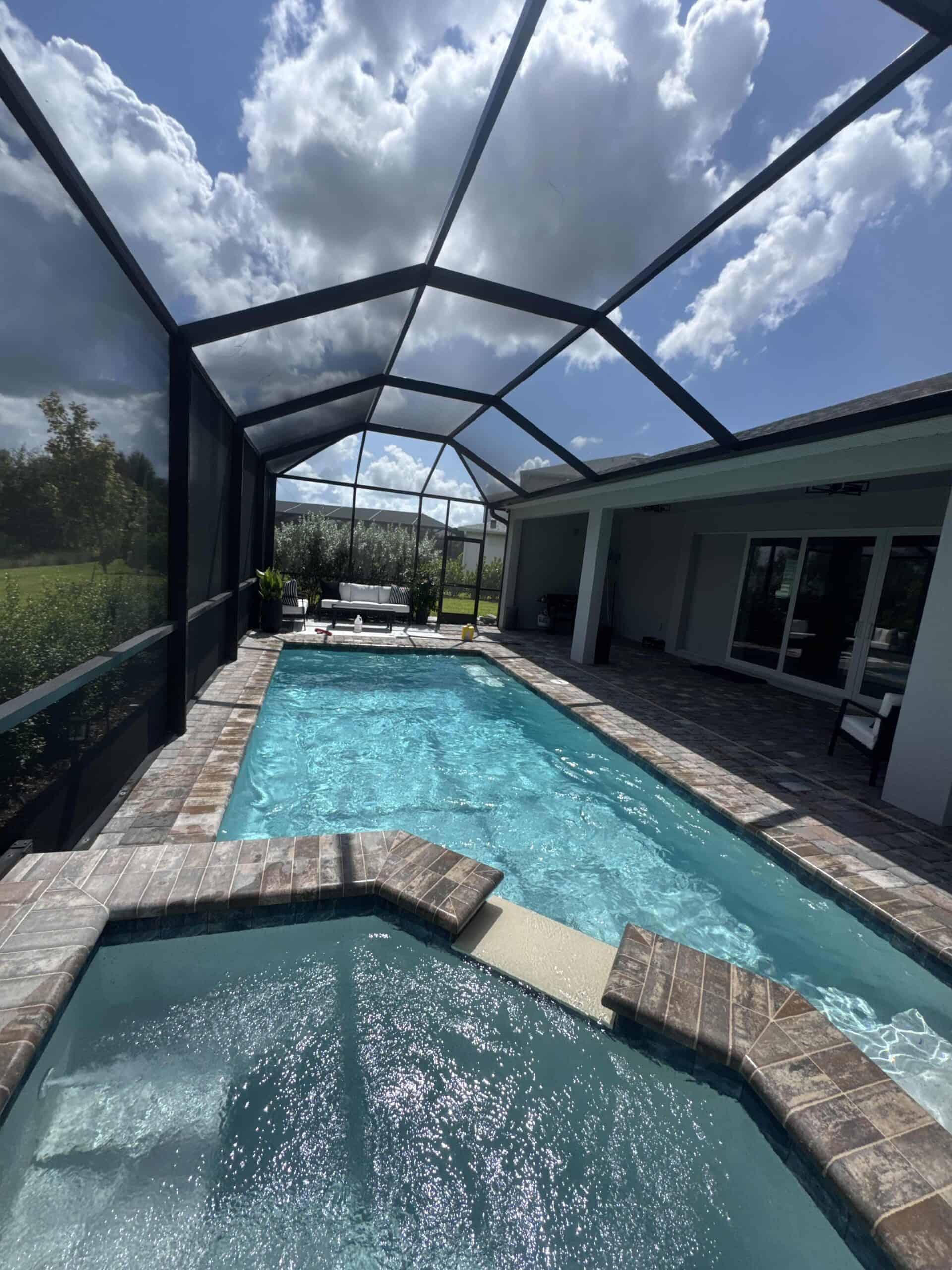 Clean screened swimming pool maintained by Pool Armor Pros