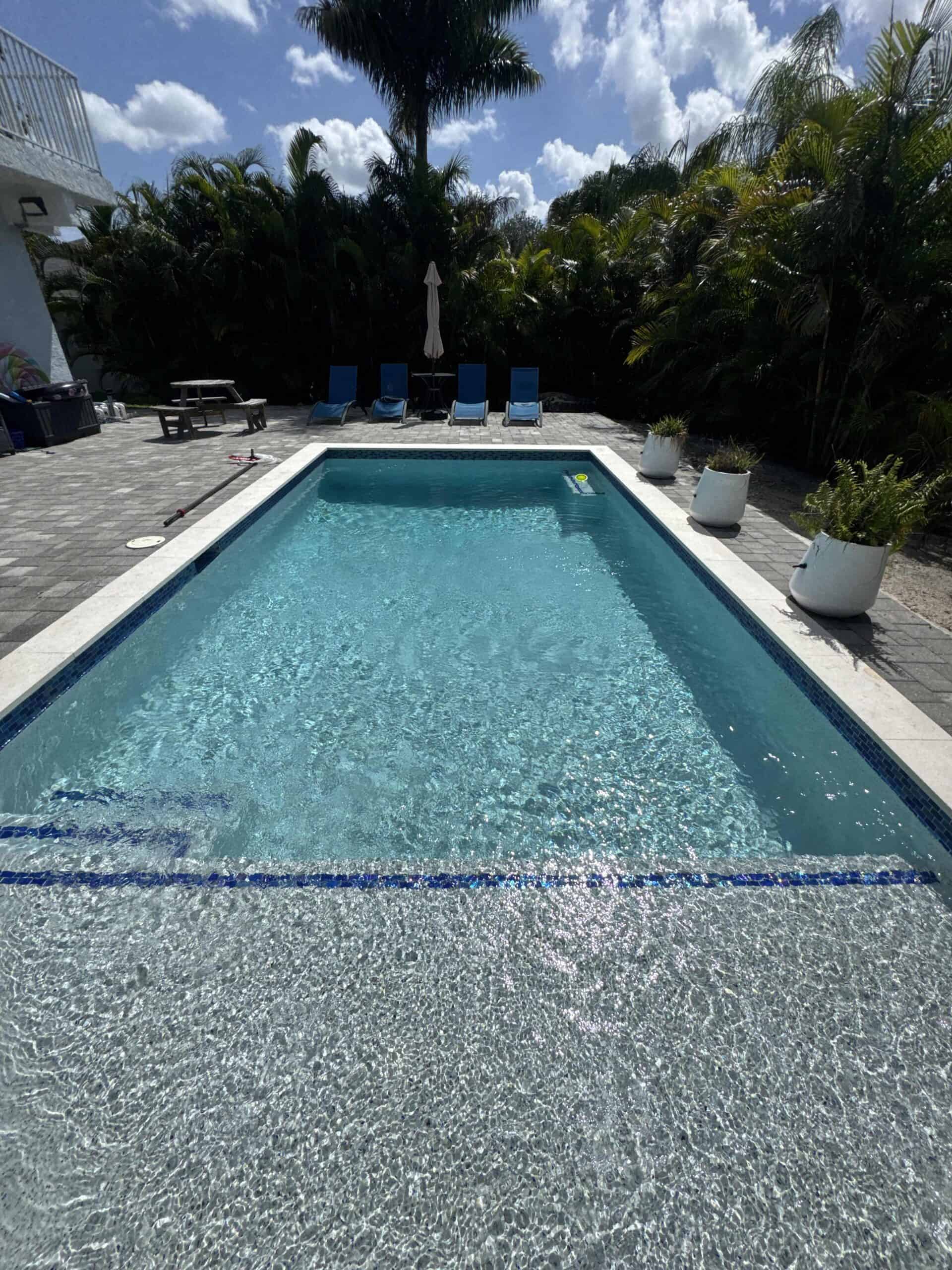 Large residential swimming pool with clear blue water